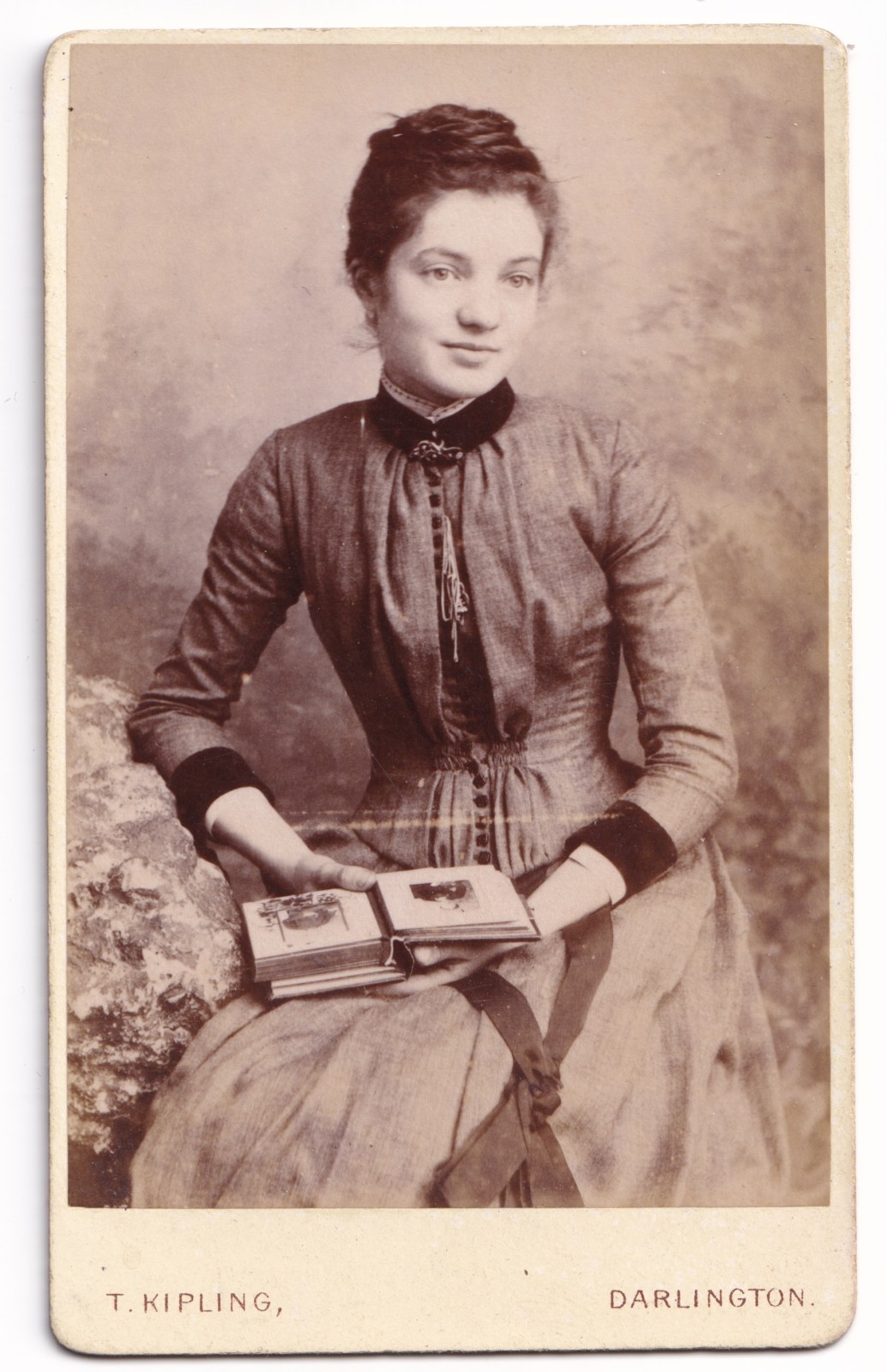 CDV: CDV: Portrait of a Young Woman Holding Photograph Album. T. Kipling, Darlington.: catalogue image 1