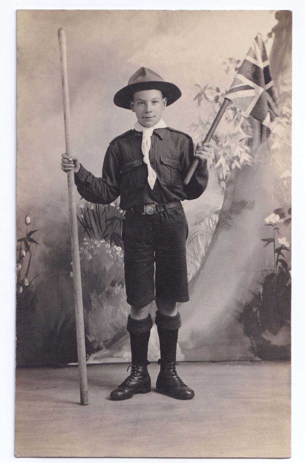 Postcard: Postcard: Boy Scout in Uniform Holding Flag and Staff. Real Photograph.: catalogue image 1